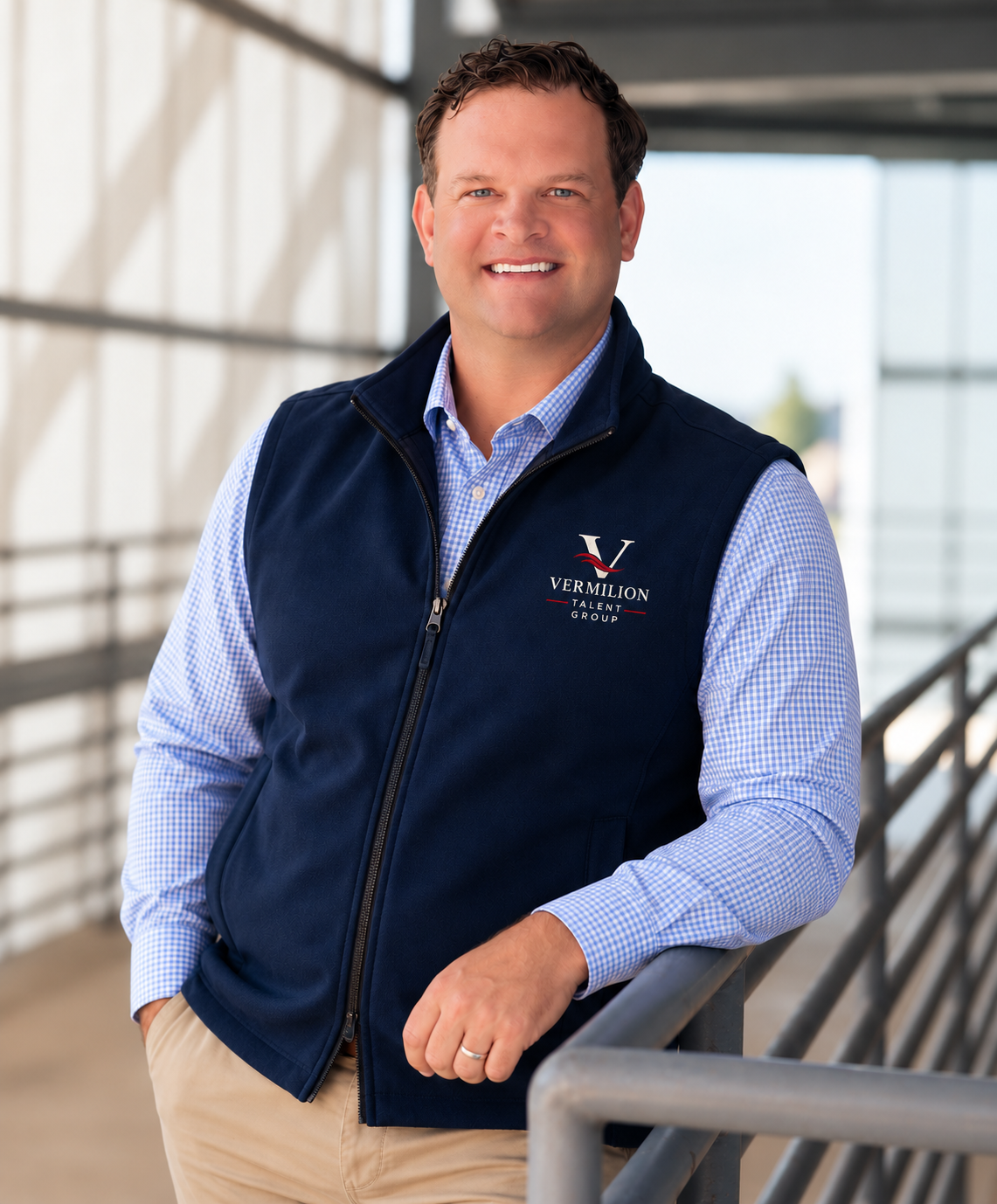 Brennan Castille wearing a navy Vermilion Talent Group vest